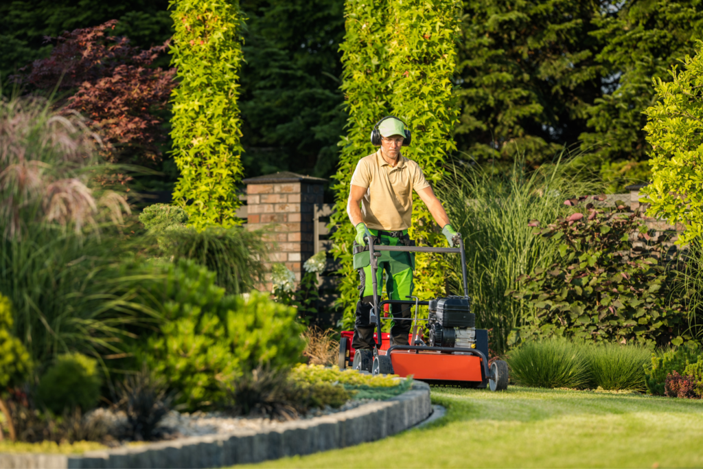 Image of man providing lawn maintenance services in a professional environment.